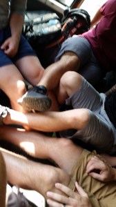 the guys trying to rest their legs in the car