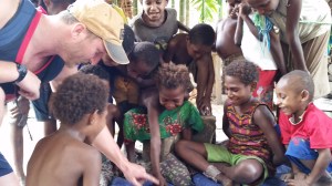 The kids got bored so Jacob started teaching them a new game.
